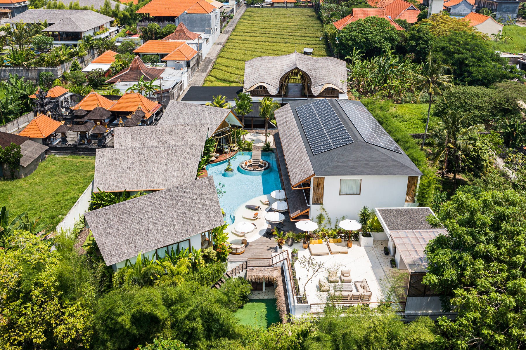 Aerial view of the Oasis retreat center with bungalows, pool and bamboo yoga shala