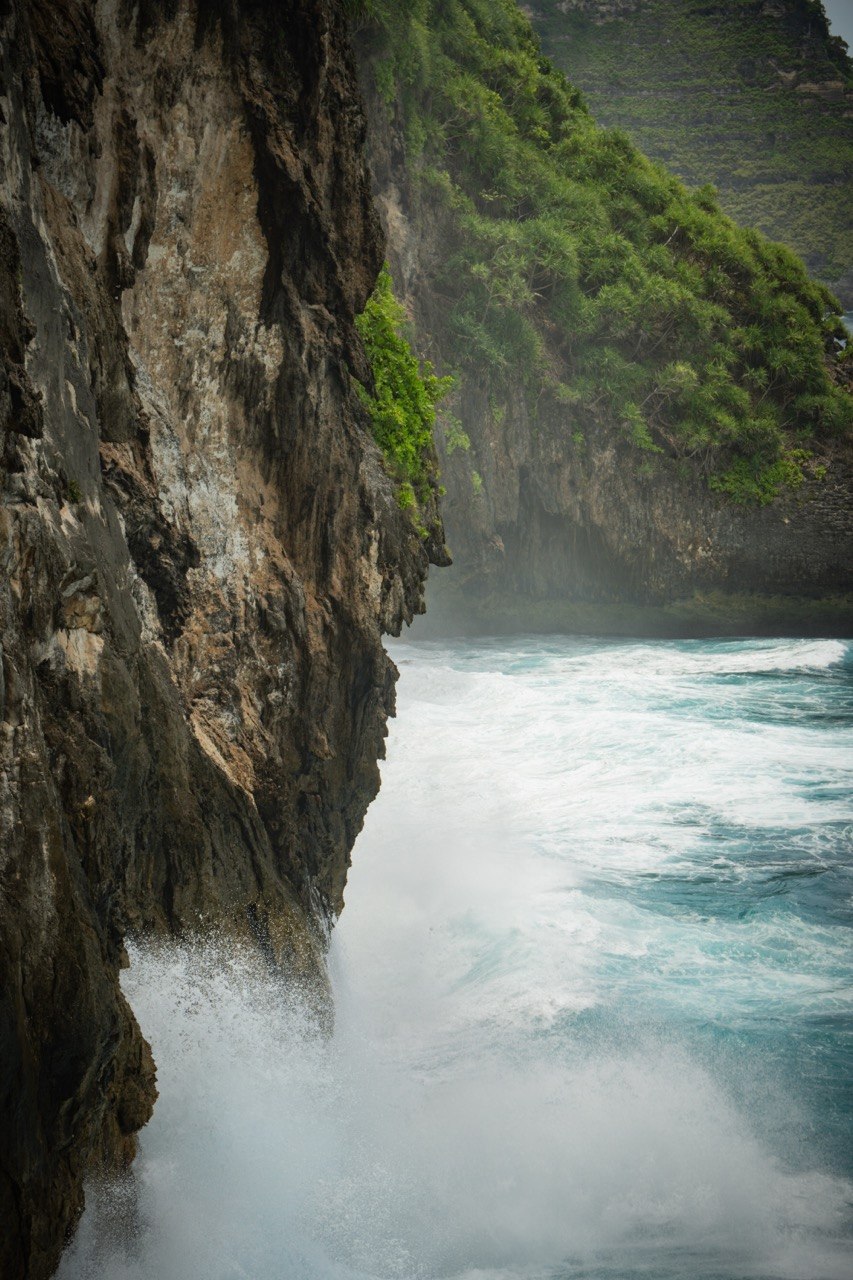 Waves crashing into cliffs